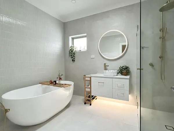 Freestanding bath and illuminated vanity